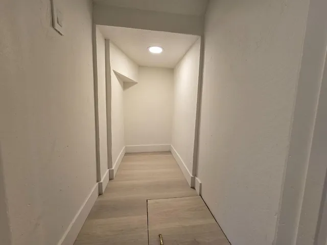 a view of a hallway with a door