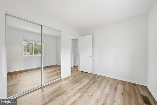 a white toilet sitting next to a shower