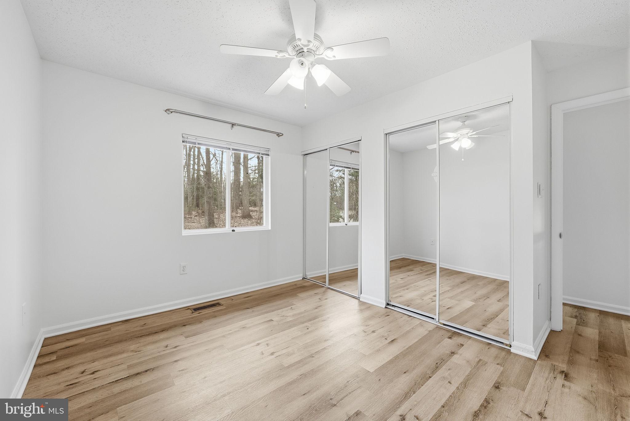 2316 Glade Bank Way Reston, VA 20191 - Photo 15 of 26 wooden floor in an empty room with a window