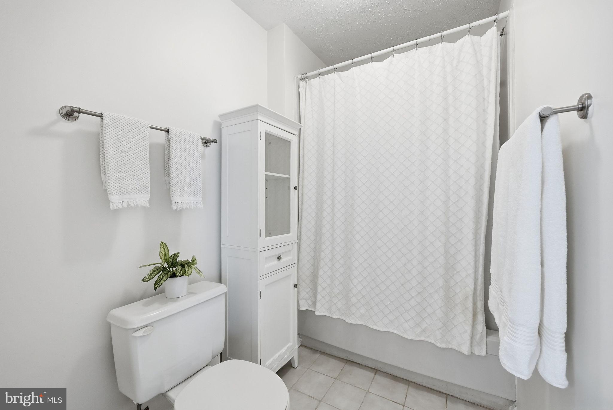 2316 Glade Bank Way Reston, VA 20191 - Photo 21 of 26 a white toilet sitting next to a shower