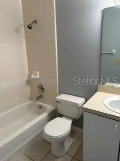 a white toilet sitting next to a bath tub