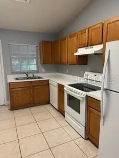 a kitchen with a stove sink and cabinets