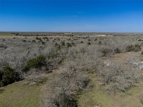 a view of a dry yard with mountains in the background