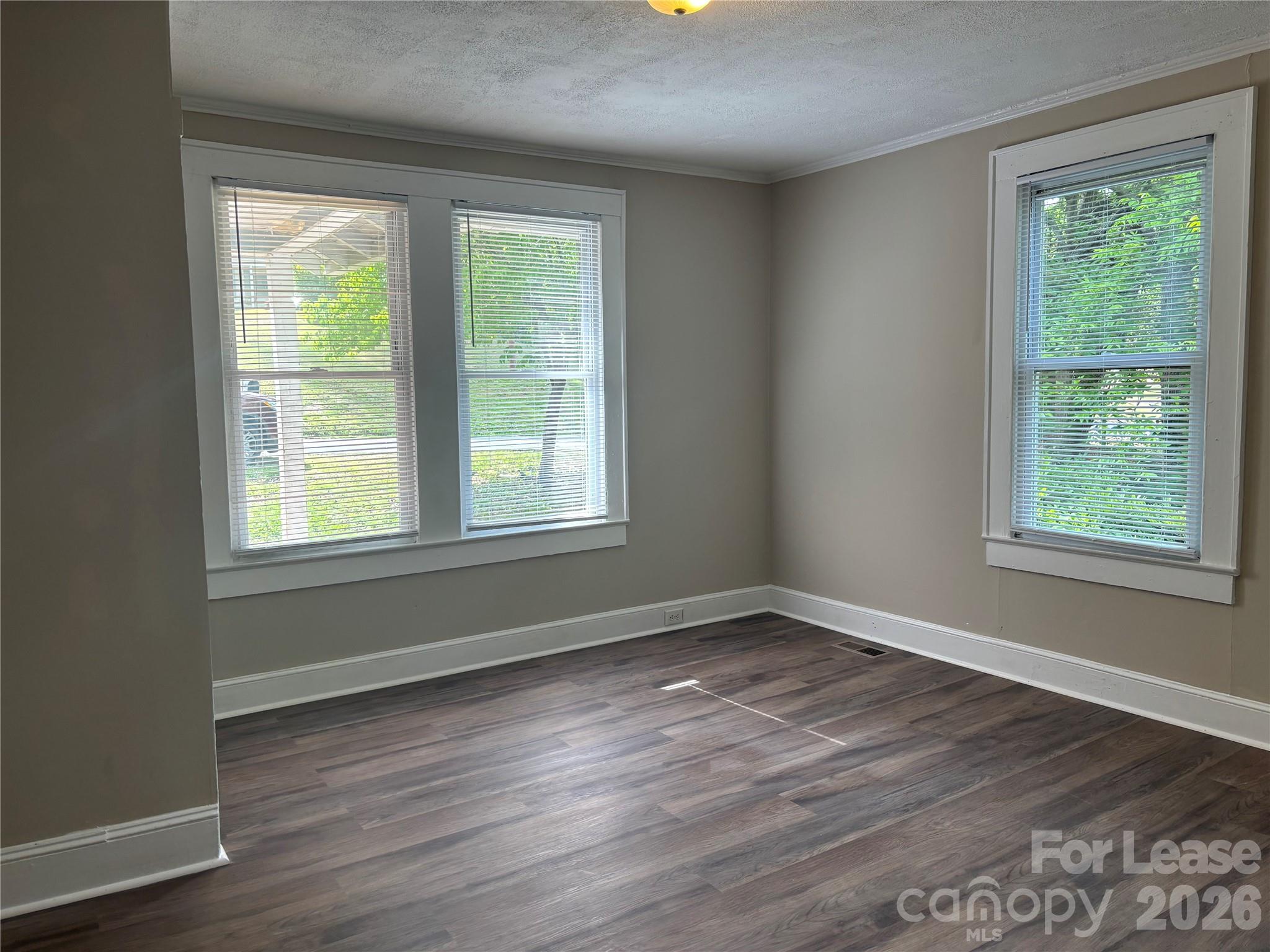 975 Old Charlotte Road Southwest Concord, NC 28027 - Photo 11 of 28 a view of an empty room with wooden floor and a window