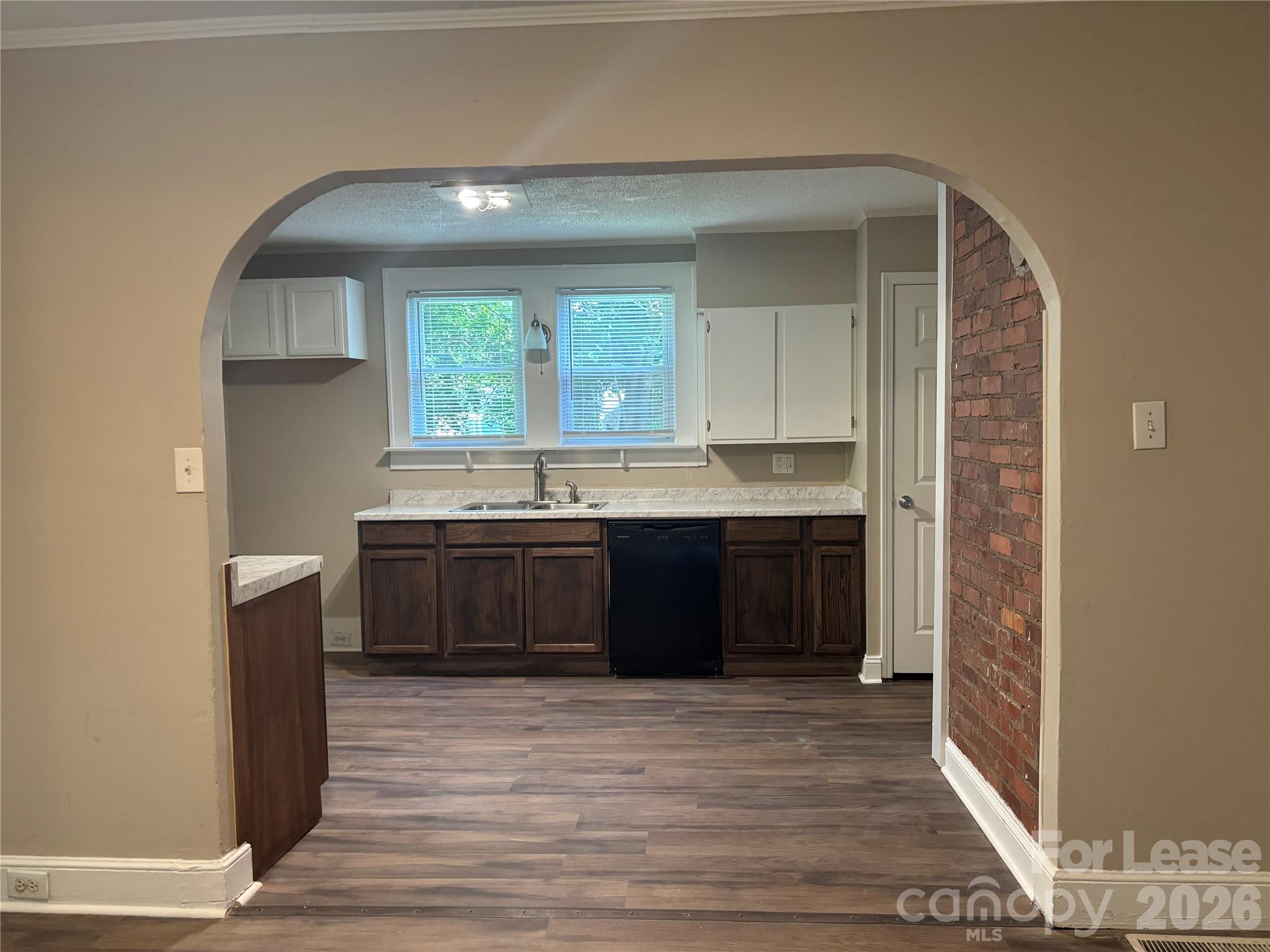 975 Old Charlotte Road Southwest Concord, NC 28027 - Photo 13 of 28 a kitchen with stainless steel appliances granite countertop a sink and cabinets