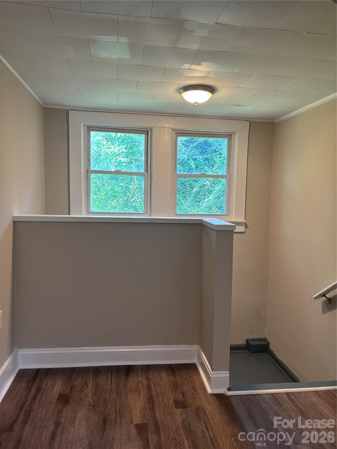 975 Old Charlotte Road Southwest Concord, NC 28027 - Photo 15 of 28 an empty room with wooden floor and windows
