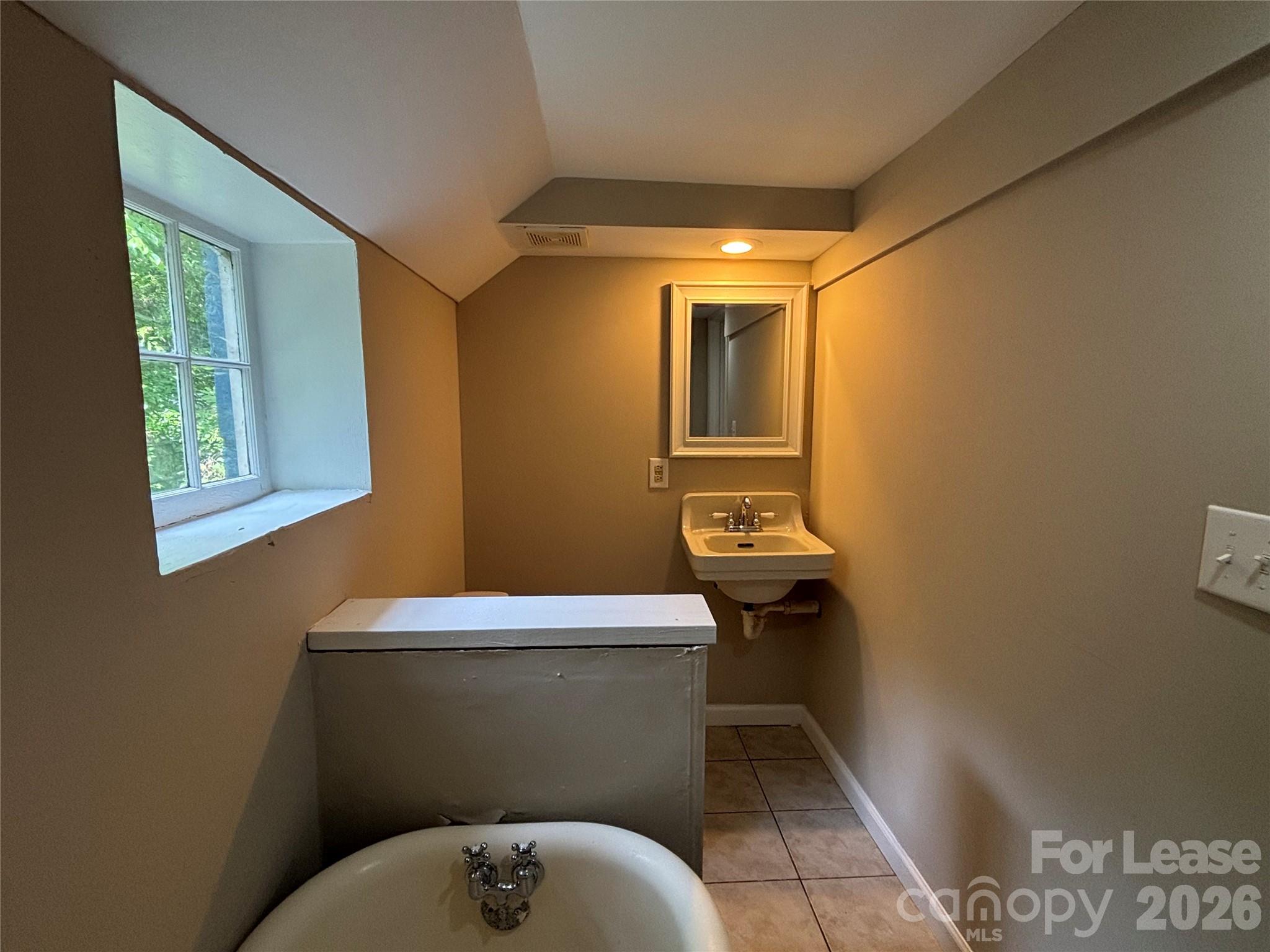 975 Old Charlotte Road Southwest Concord, NC 28027 - Photo 18 of 28 a bathroom with a toilet a sink and mirror
