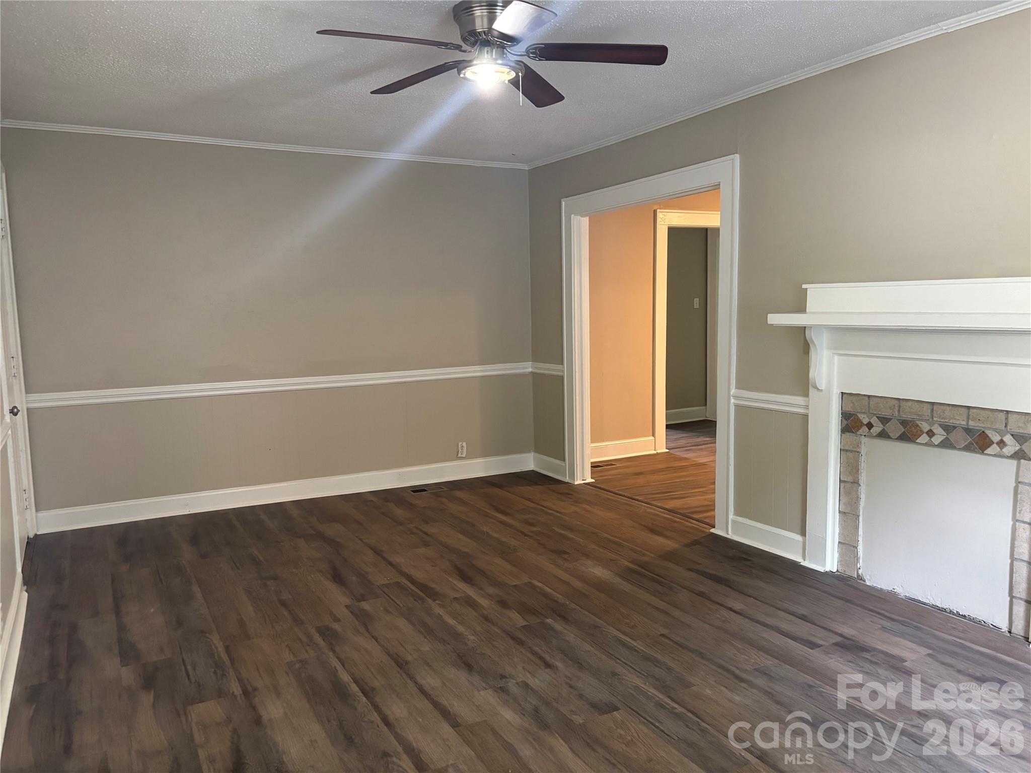 975 Old Charlotte Road Southwest Concord, NC 28027 - Photo 2 of 28 an empty room with wooden floor fireplace and windows