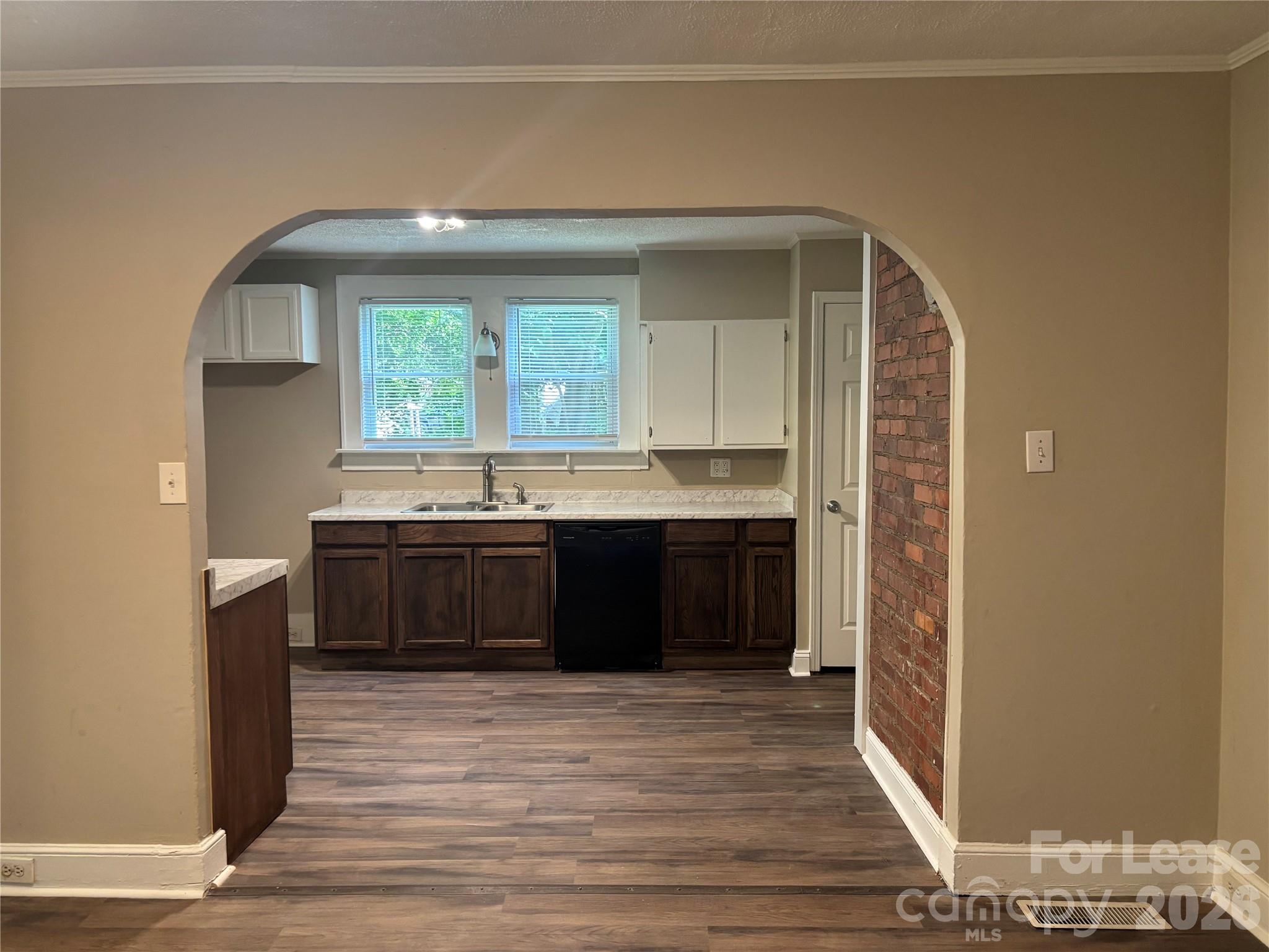 975 Old Charlotte Road Southwest Concord, NC 28027 - Photo 4 of 28 a kitchen with stainless steel appliances a sink and a wooden floor