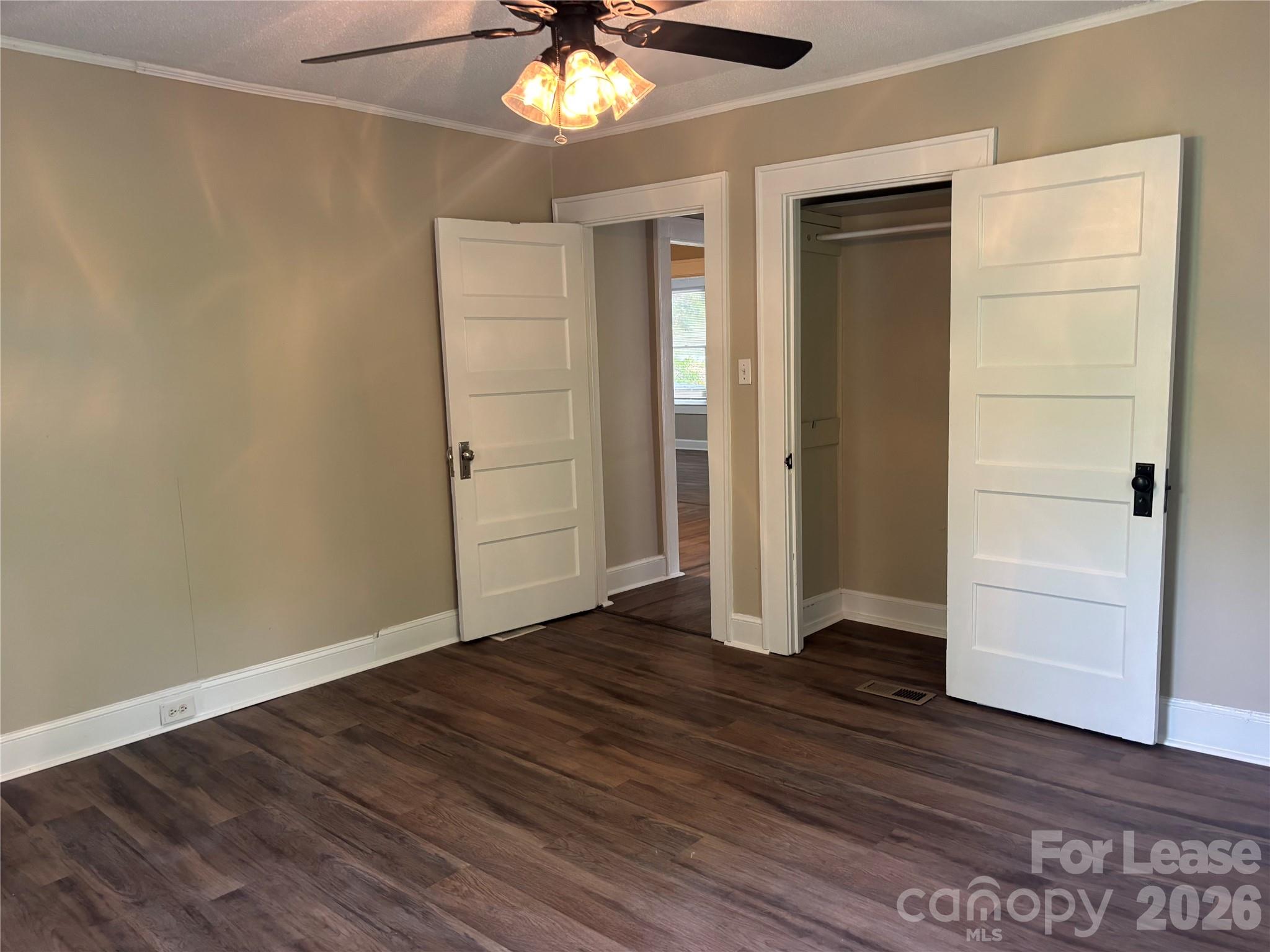 975 Old Charlotte Road Southwest Concord, NC 28027 - Photo 5 of 28 an empty room with wooden floor closet and windows