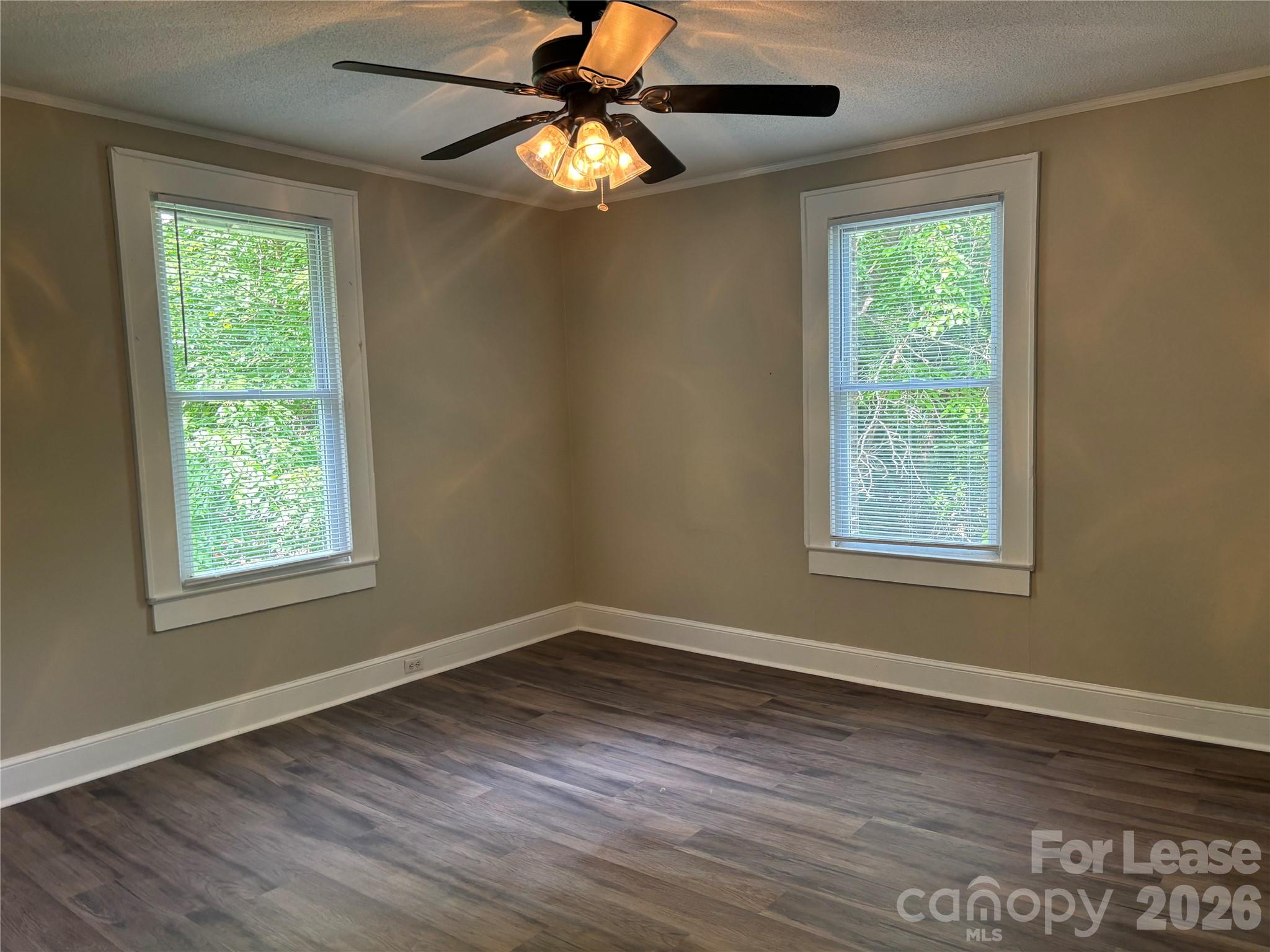 975 Old Charlotte Road Southwest Concord, NC 28027 - Photo 6 of 28 a view of an empty room with wooden floor and window