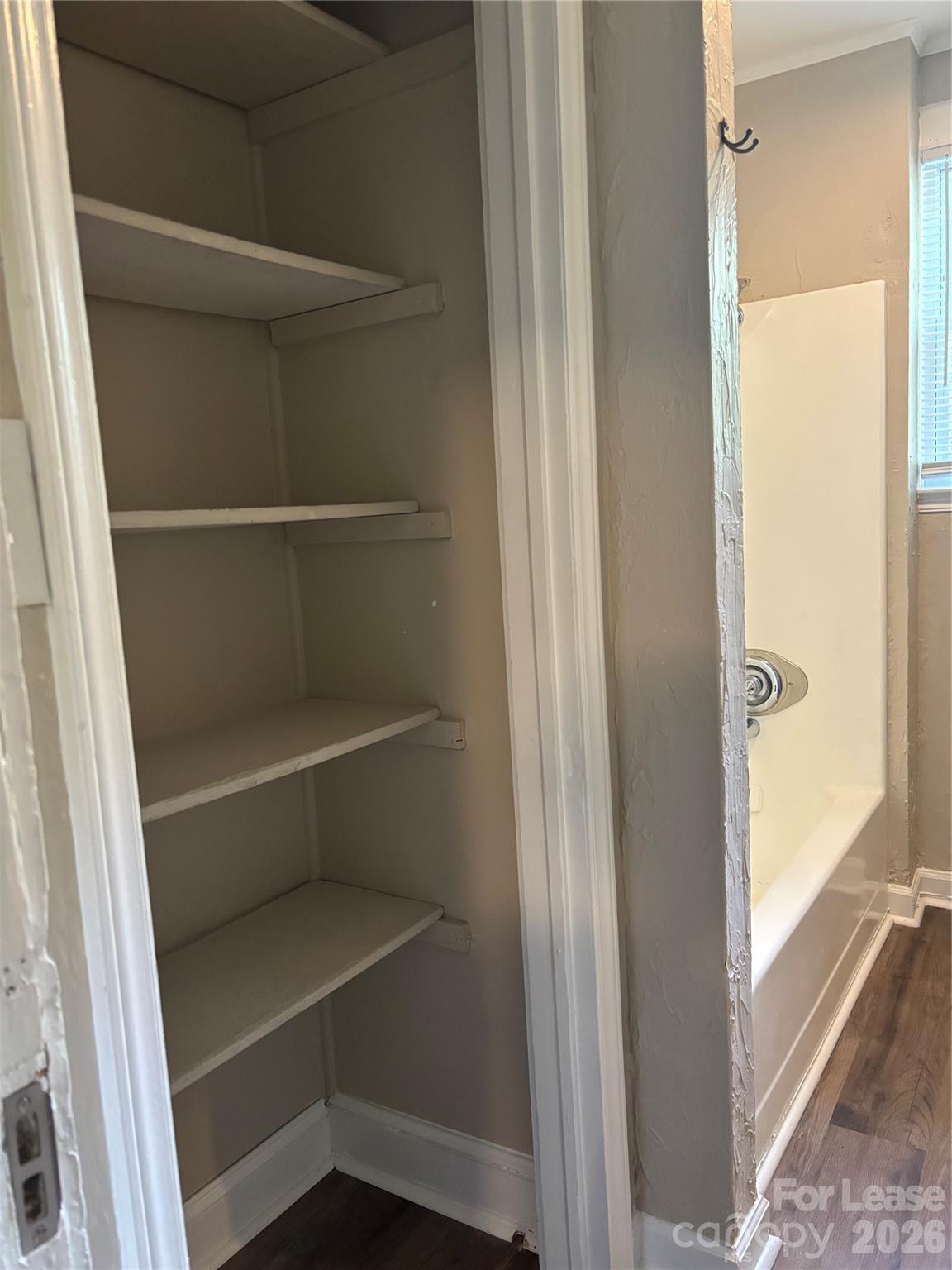 975 Old Charlotte Road Southwest Concord, NC 28027 - Photo 9 of 28 a view of walk in closet with empty racks
