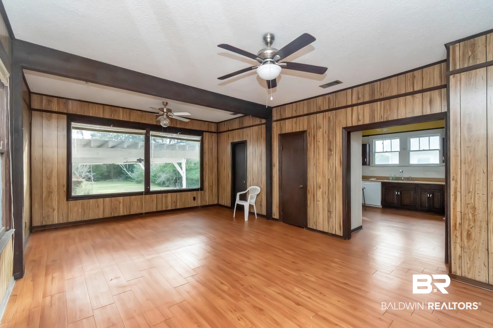 4305 Stein Street Mobile, AL 36608 - Photo 13 of 22 Interior space featuring wood walls, sink, light hardwood / wood-style flooring, ceiling fan, and beamed ceiling