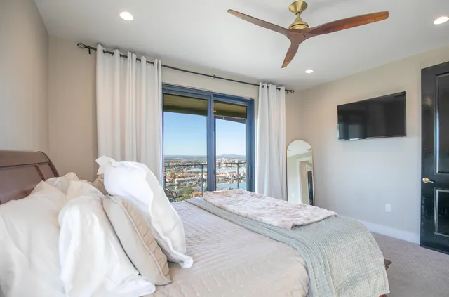 a bedroom with a bed tv and a window