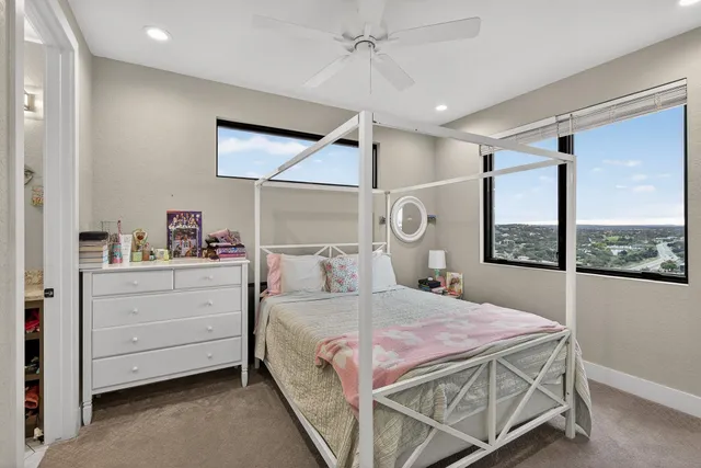 a bedroom with a large bed and a window