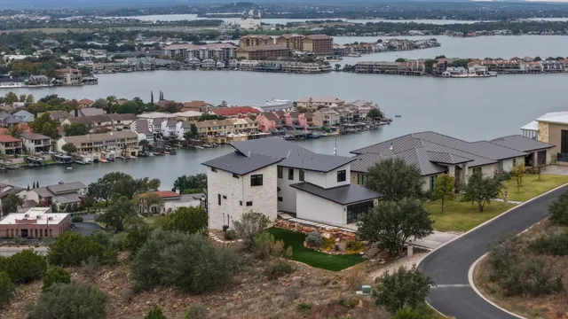 an aerial view of a house with a lake view