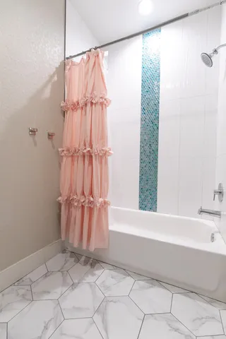 a bathroom with a bathtub and a shower
