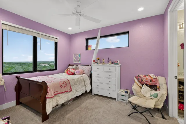 a bedroom with a bed dresser and a window