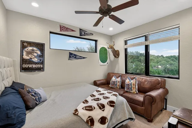 a bedroom with furniture and a large window