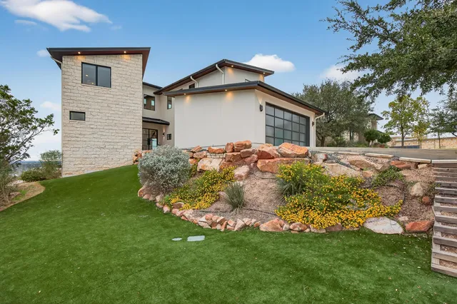a front view of house with yard and green space