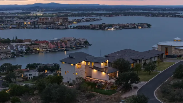 an aerial view of residential houses with outdoor space and river