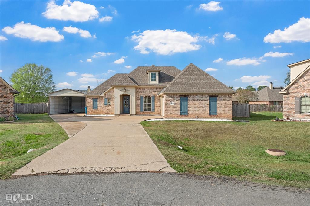 4429 Ellis Court Benton, LA 71006 - Photo 1 of 1 a front view of a house with a garden
