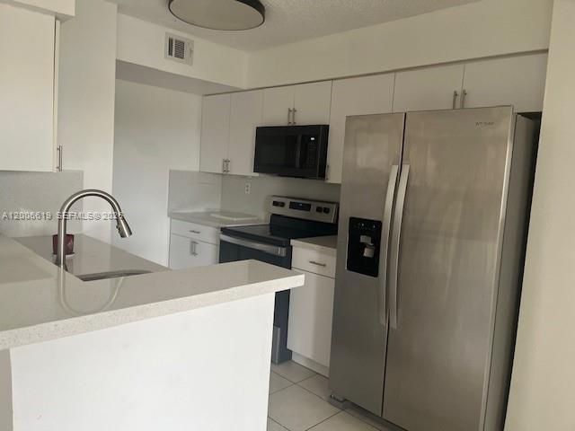 15231 Southwest 80th Street, Unit 503 Miami, FL 33193 - Photo 1 of 9 a kitchen with stainless steel appliances a refrigerator and a sink