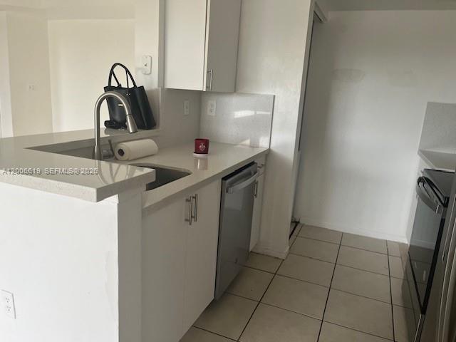 15231 Southwest 80th Street, Unit 503 Miami, FL 33193 - Photo 2 of 9 a kitchen with a sink and a stove