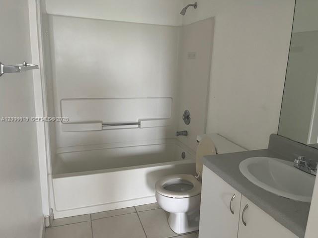 15231 Southwest 80th Street, Unit 503 Miami, FL 33193 - Photo 4 of 9 a bathroom with a granite countertop bathtub shower sink and toilet