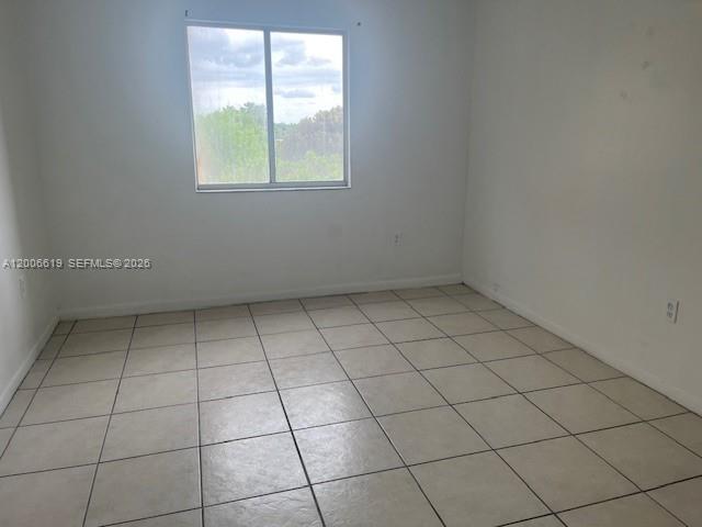 15231 Southwest 80th Street, Unit 503 Miami, FL 33193 - Photo 5 of 9 an empty room with a window