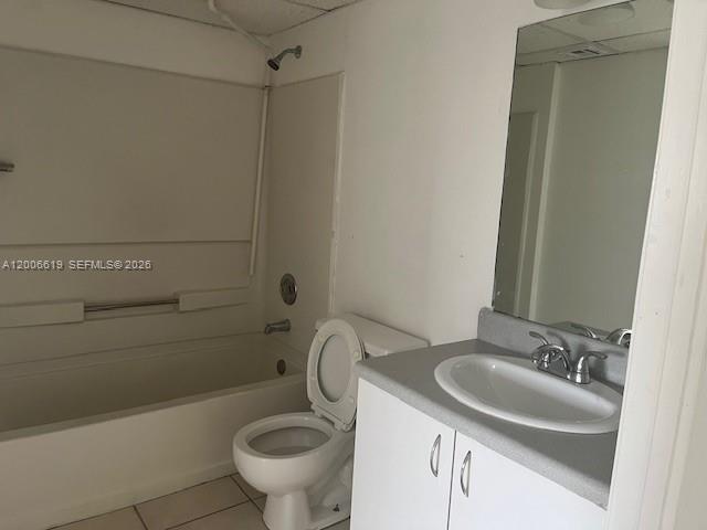 15231 Southwest 80th Street, Unit 503 Miami, FL 33193 - Photo 6 of 9 a bathroom with a sink a toilet and a mirror