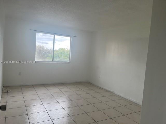 15231 Southwest 80th Street, Unit 503 Miami, FL 33193 - Photo 7 of 9 an empty room with a window