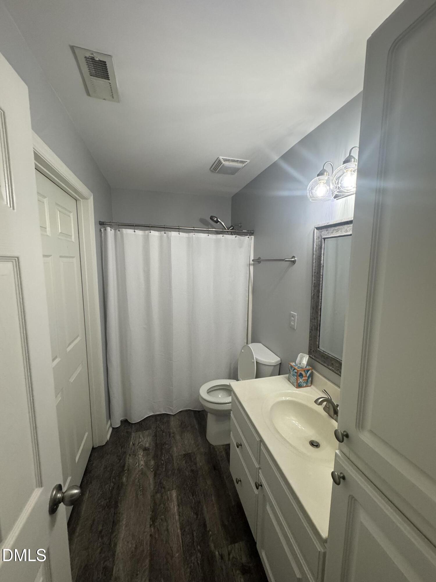 11351 Clubhaven Place, Unit 100 Raleigh, NC 27617 - Photo 29 of 29 a bathroom with a double vanity sink toilet and shower