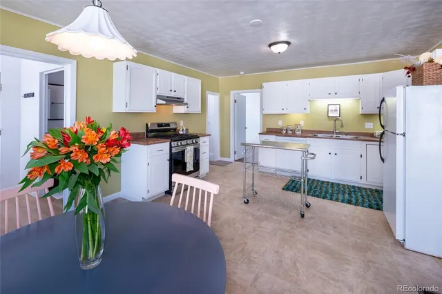 a view of kitchen with furniture and chandelier