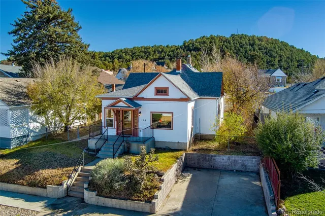 a front view of house with yard and green space