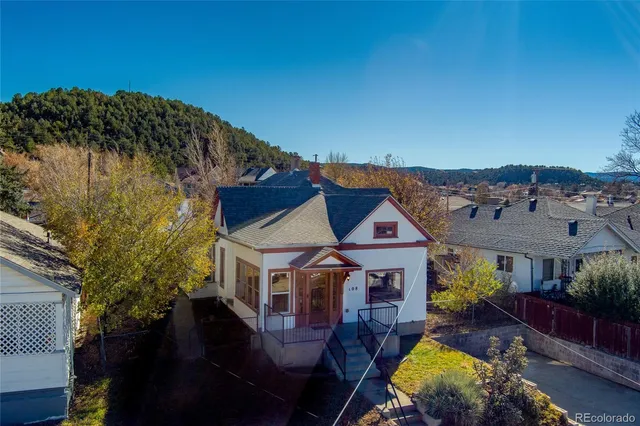 an aerial view of a house with swimming pool table and chairs