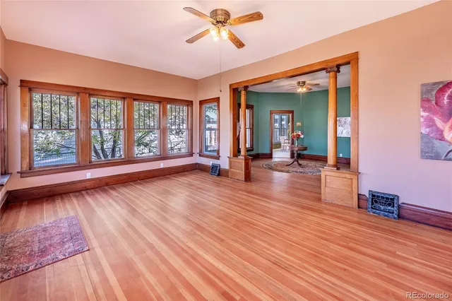 wooden floor in an empty room with a window