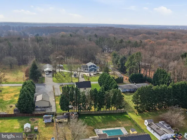 an aerial view of house with yard swimming pool and outdoor seating