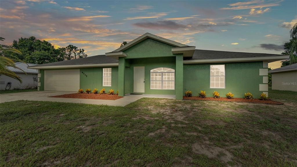 4515 Starfish Avenue Sebring, FL 33870 - Photo 11 of 38 a front view of a house with a garden