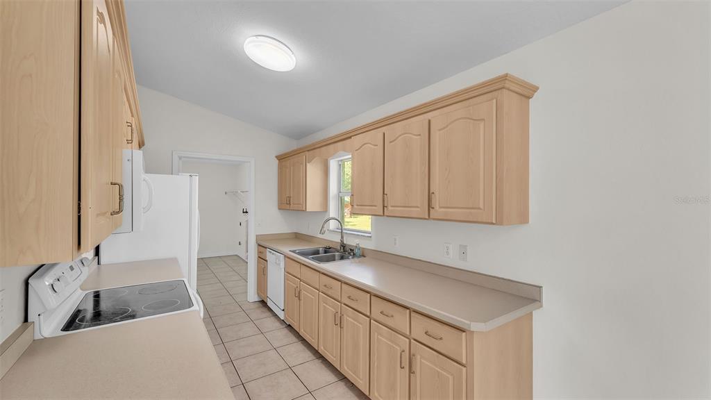 4515 Starfish Avenue Sebring, FL 33870 - Photo 19 of 38 a kitchen with stainless steel appliances granite countertop a sink stove and cabinets