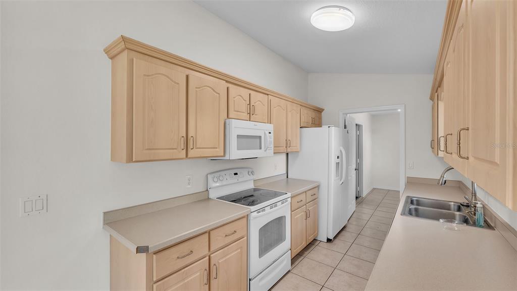 4515 Starfish Avenue Sebring, FL 33870 - Photo 20 of 38 a kitchen with stainless steel appliances granite countertop a sink and cabinets