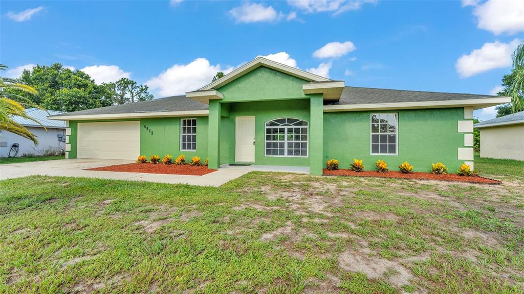 4515 Starfish Avenue Sebring, FL 33870 - Photo 2 of 38 a front view of a house with a yard and garage