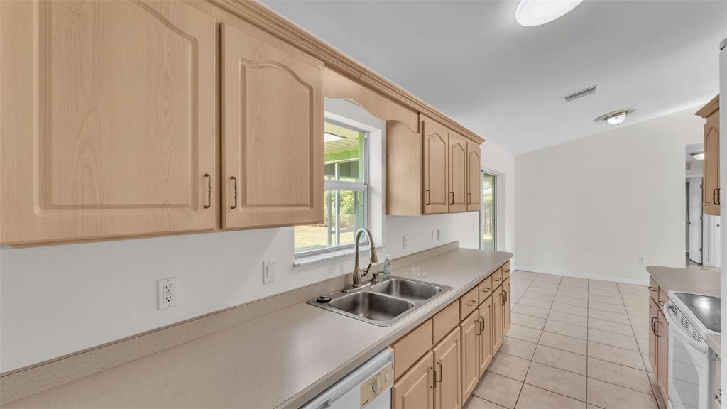 4515 Starfish Avenue Sebring, FL 33870 - Photo 22 of 38 a kitchen with a sink and cabinets