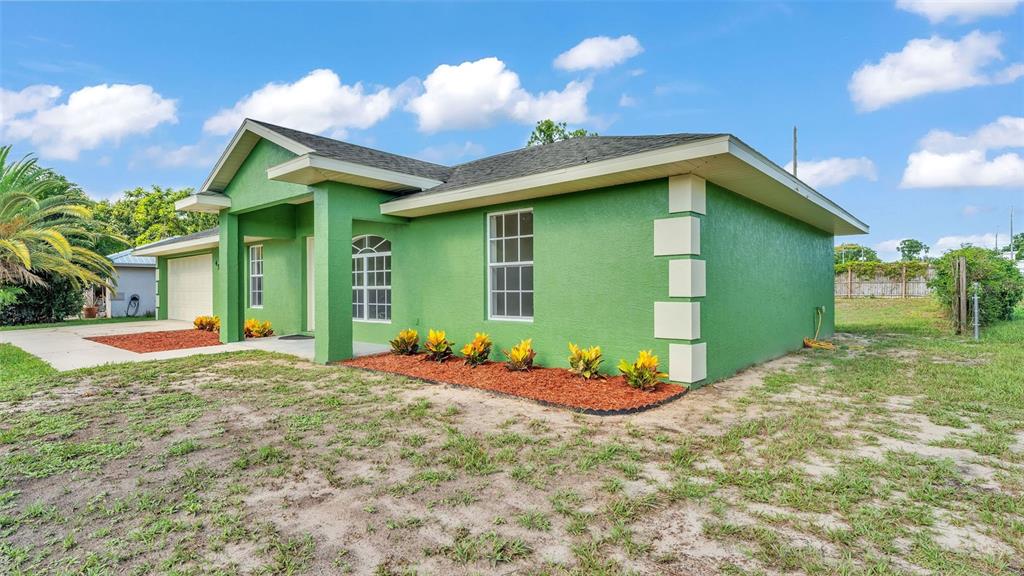 4515 Starfish Avenue Sebring, FL 33870 - Photo 3 of 38 a front view of a house with garden