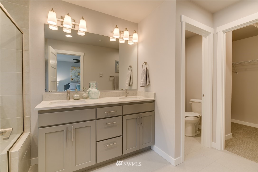 1225 Filbert Road, Unit F1 Lynnwood, WA 98036 - Photo 17 of 25 a bathroom with a double vanity sink and a mirror