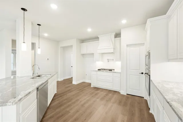 a large kitchen with kitchen island a sink stainless steel appliances and cabinets