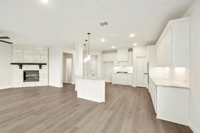 a view of a kitchen with a sink and a refrigerator