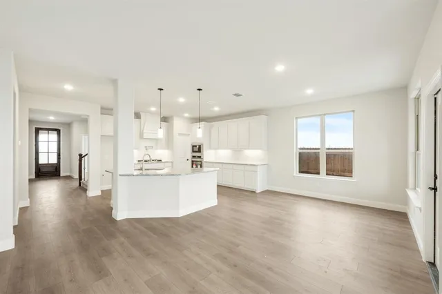 a view of a kitchen with a sink and a large window