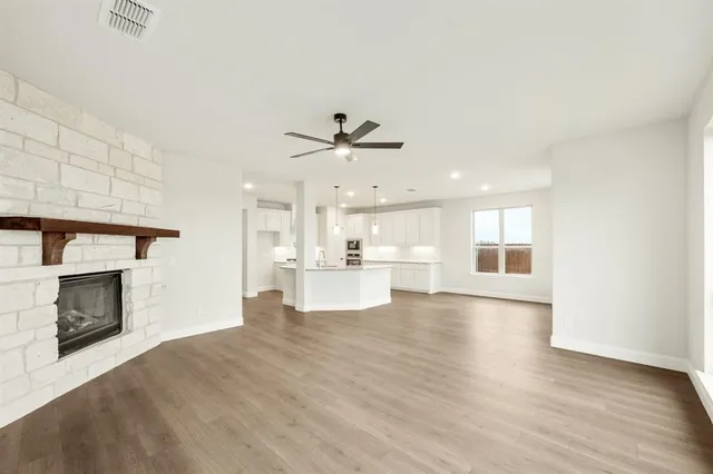 a view of a kitchen with a sink and a fireplace