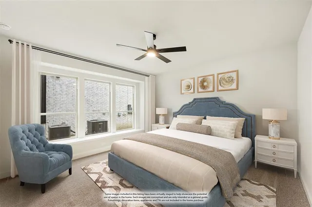 a spacious bedroom with a bed couch and a large window